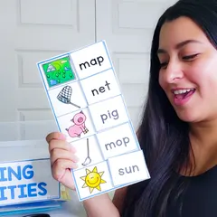 Martha Galvan holding a CVC matching mat with the words map, net, pig, mop and sun